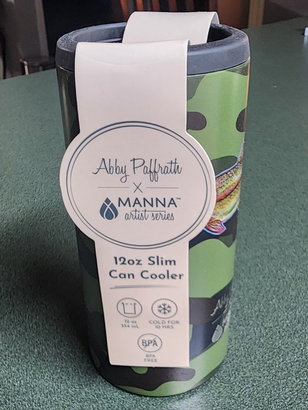 Abby Paffrath x Manna 12oz Slim Can Cooler - Green Camo with fish art.